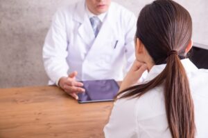 A doctor and nurse having a conference at the hospital.