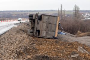 Image showing a truck rollover accident, with the vehicle overturned on its side