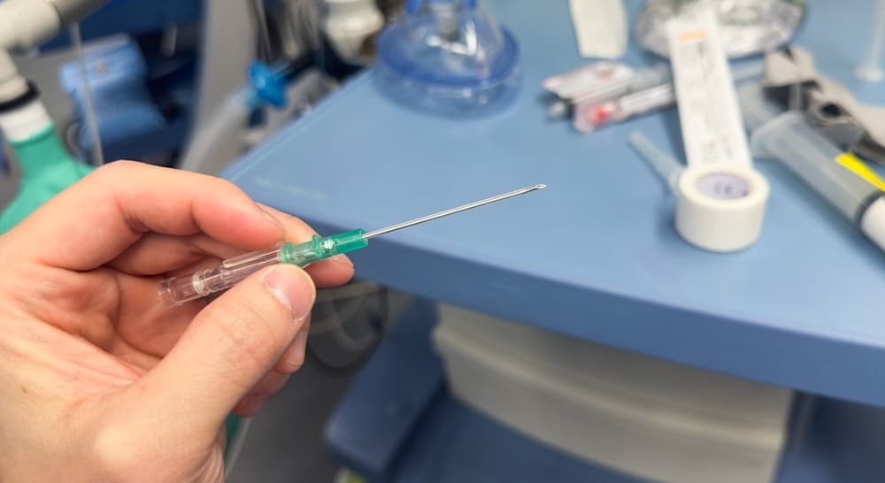 Close-up of a needle and syringe in a hospital setting, illustrating the risks of anesthesia mistakes and medication errors.