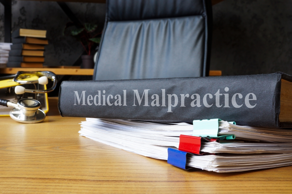 Medical malpractice documents on a table.