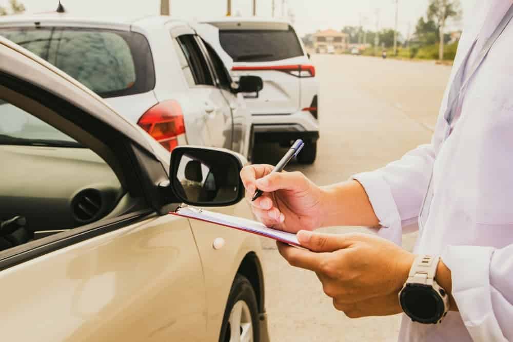 An insurance officer documented a crash, aiding clients after a reckless uninsured driver caused damage.